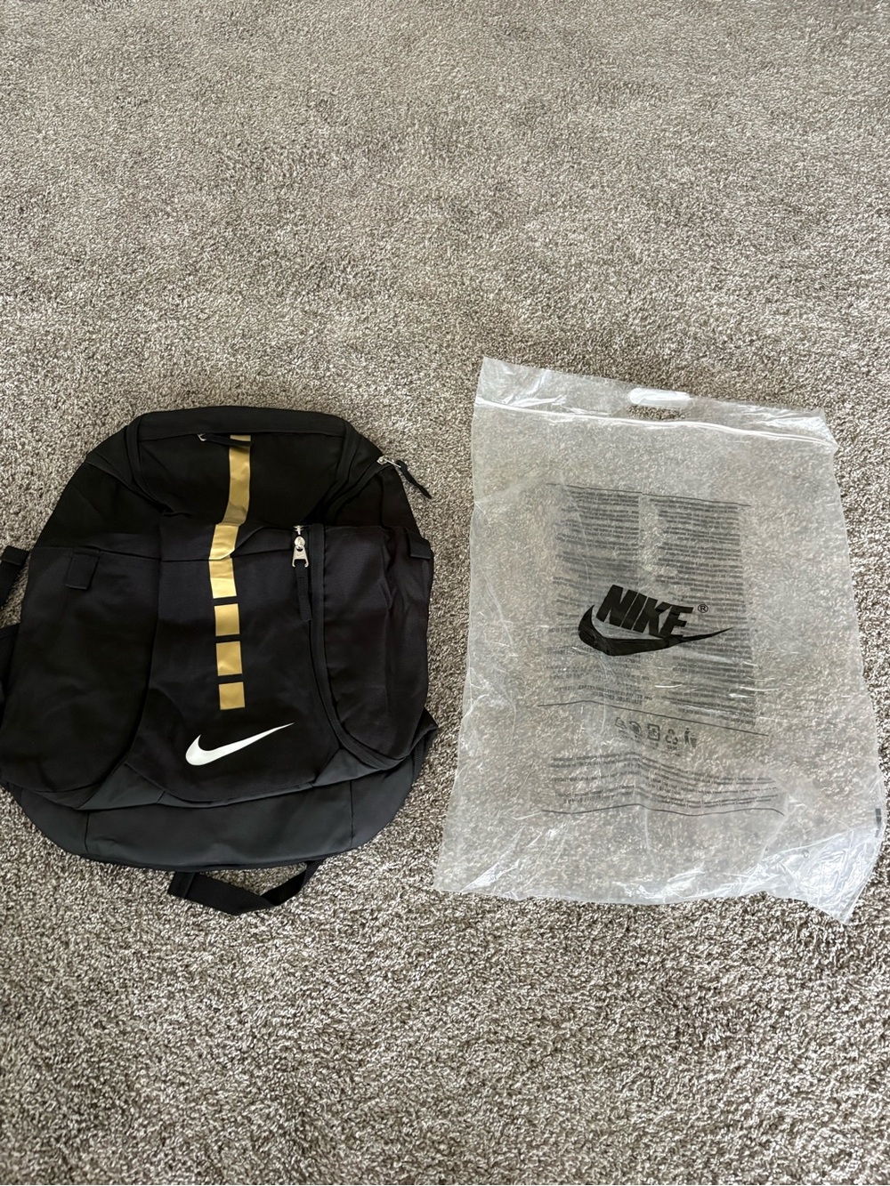 Nike Black Backpack with Gold Stripe and White Swoosh